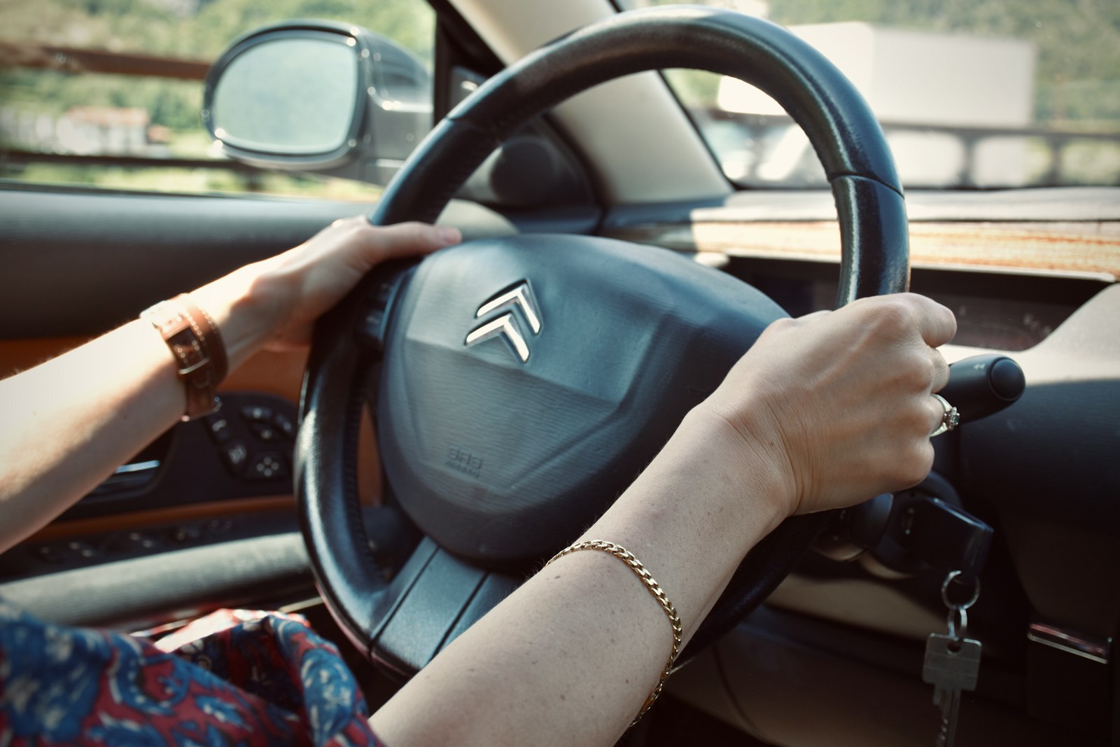 Photo by Arno Senoner person holding black honda steering wheel