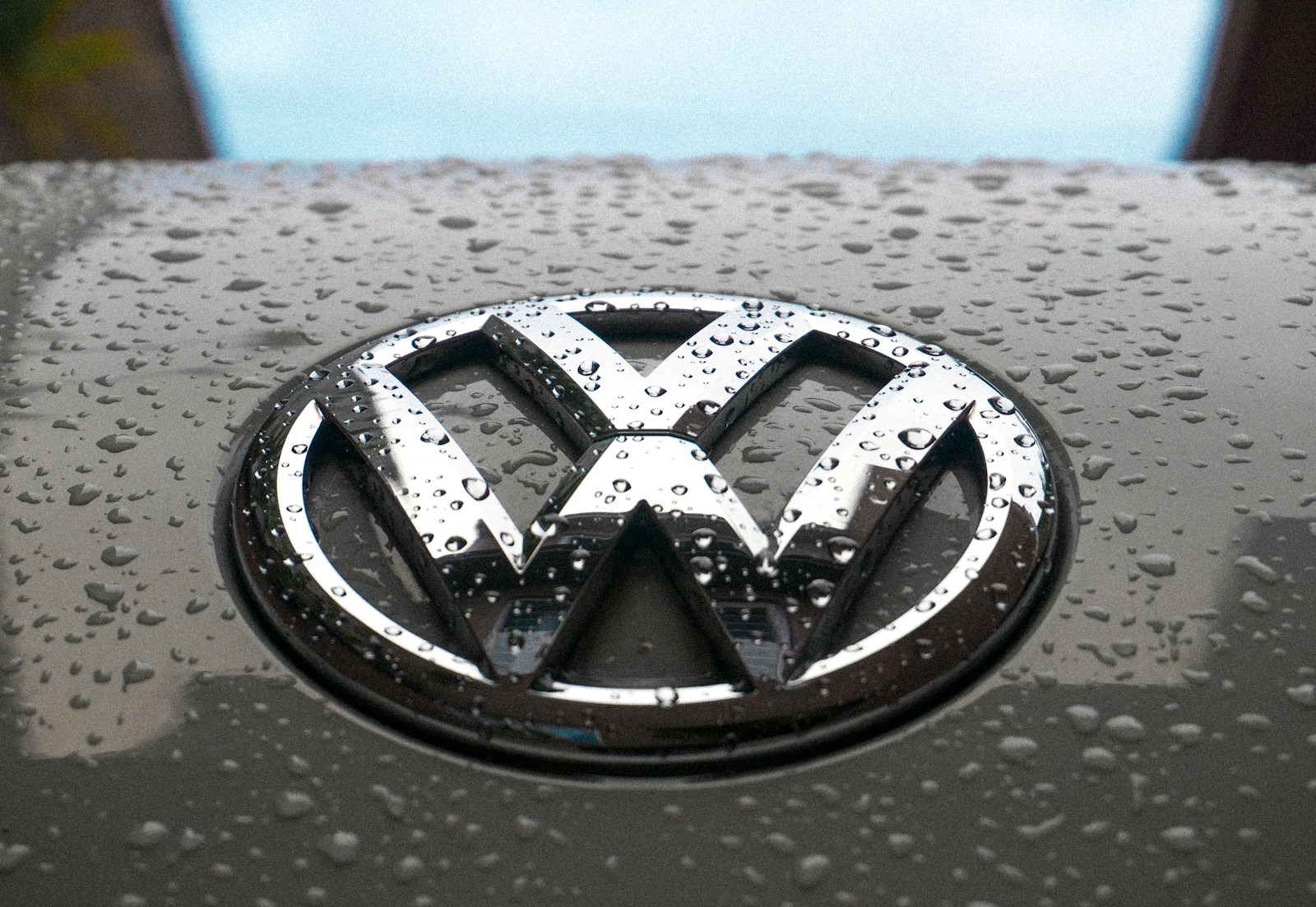 Photo by Cesar Salazar water dew on silver Volkswagen car emblem