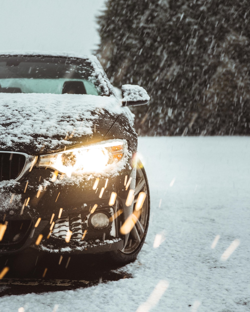 Photo by Danny Sleeuwenhoek black car on snow covered road during daytime