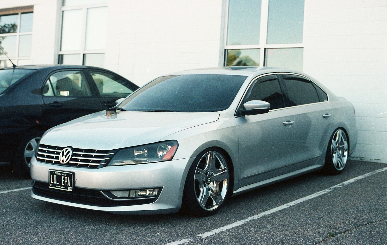 Photo by Paul Esch-Laurent A silver car parked next to a black car in a parking lot