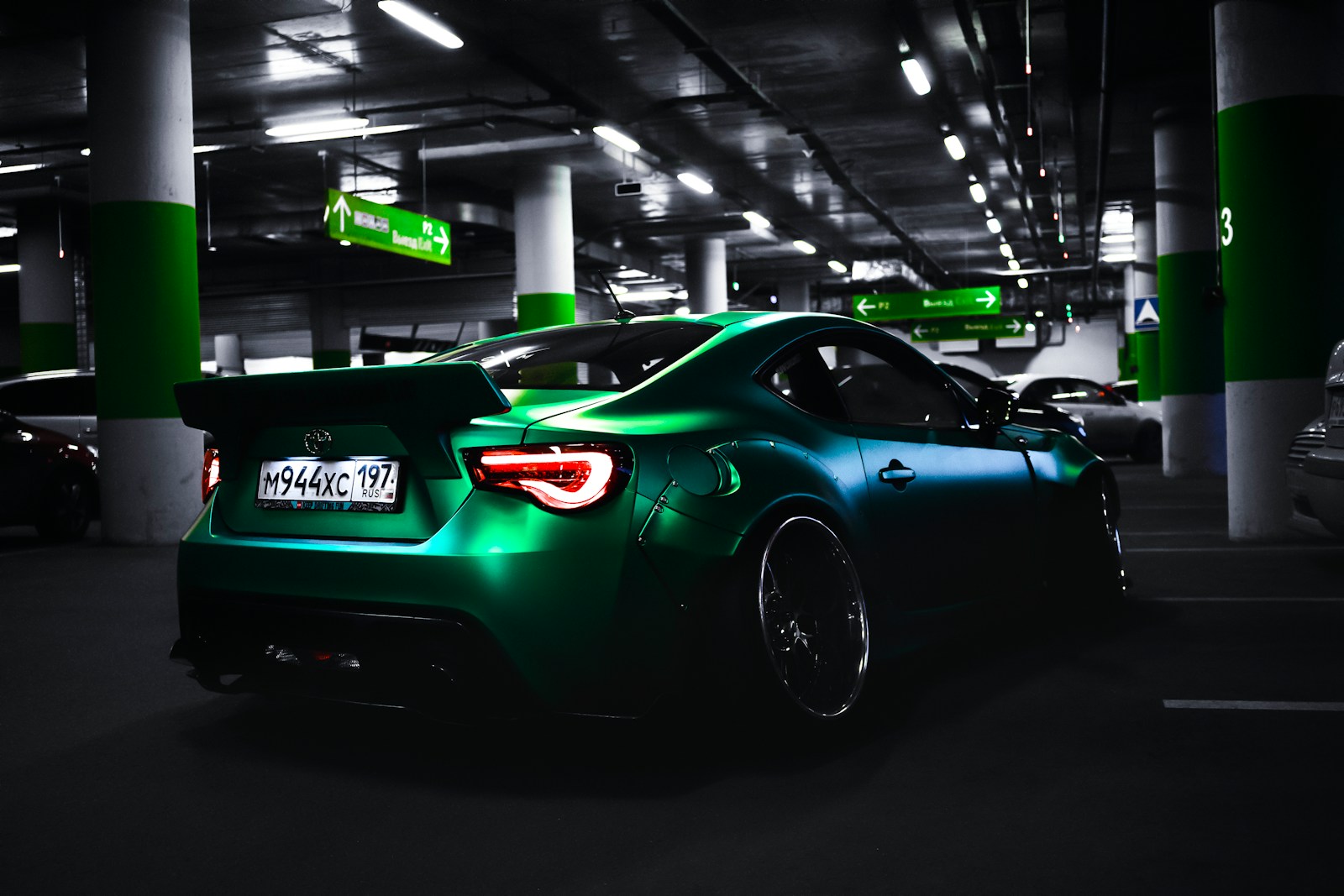 Photo by Serge Kutuzov green coup inside parking area