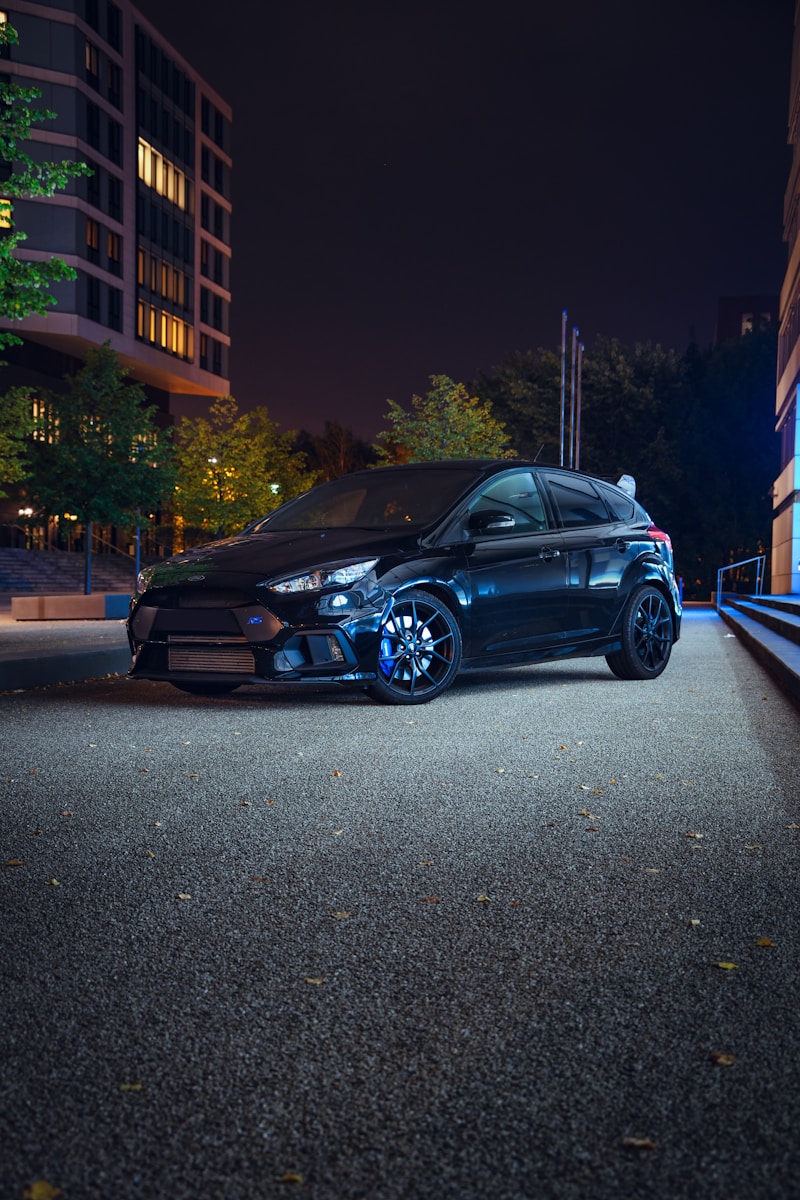 a car parked on the side of the road at night