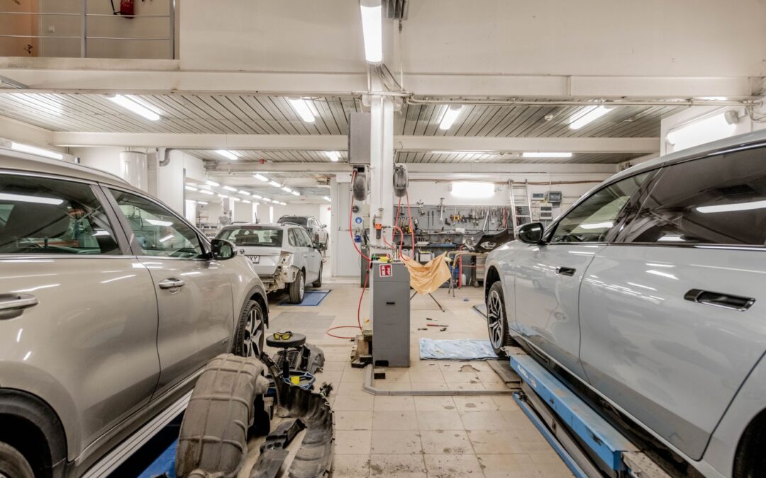 Does a remap void your warranty: service paperwork being reviewed beside a car in a workshop