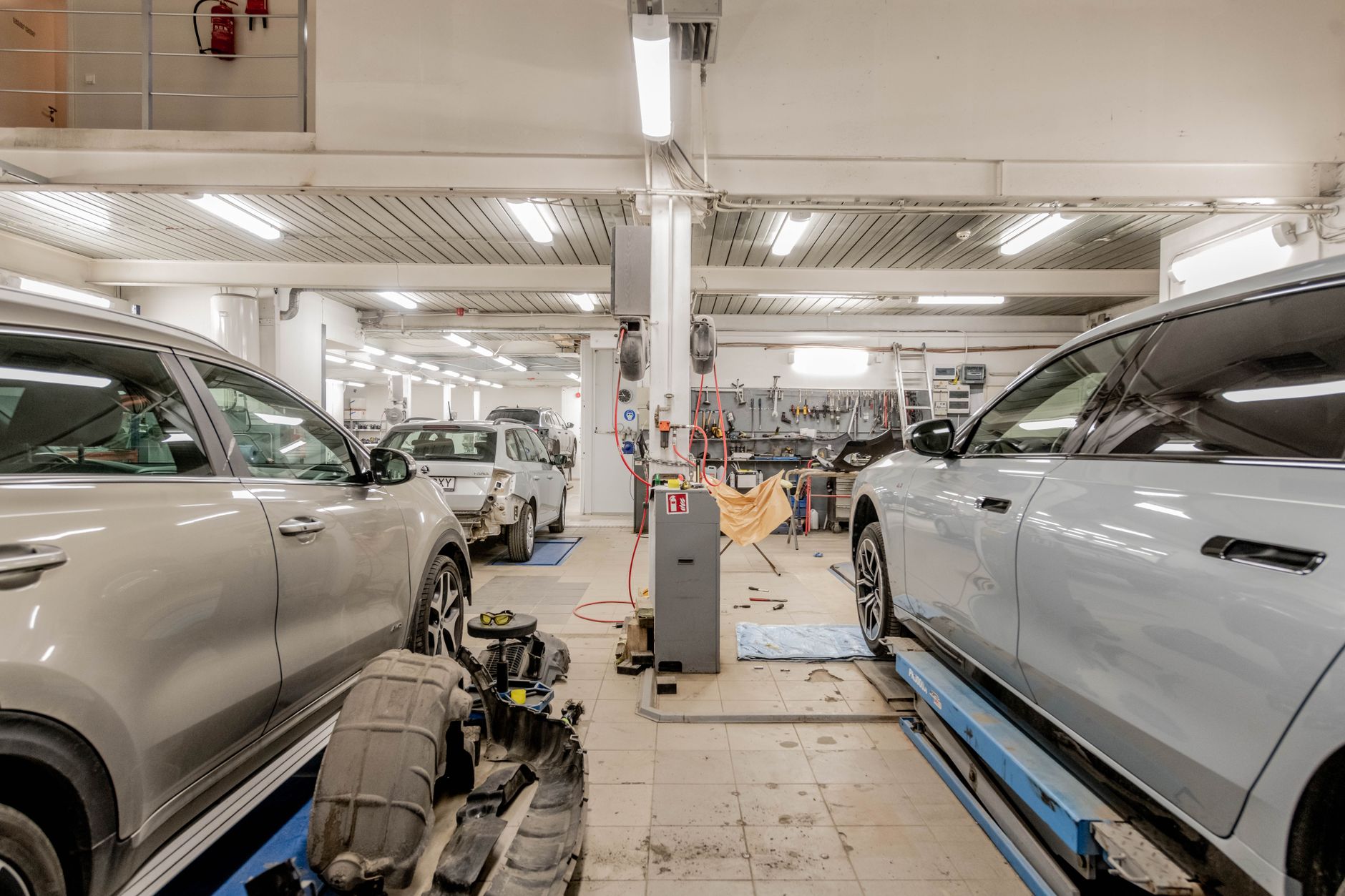 Does a remap void your warranty: service paperwork being reviewed beside a car in a workshop
