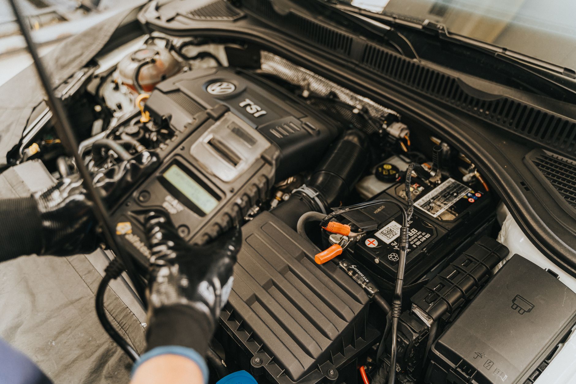 Tuning box vs remap comparison: laptop connected to a diesel car ECU in a workshop